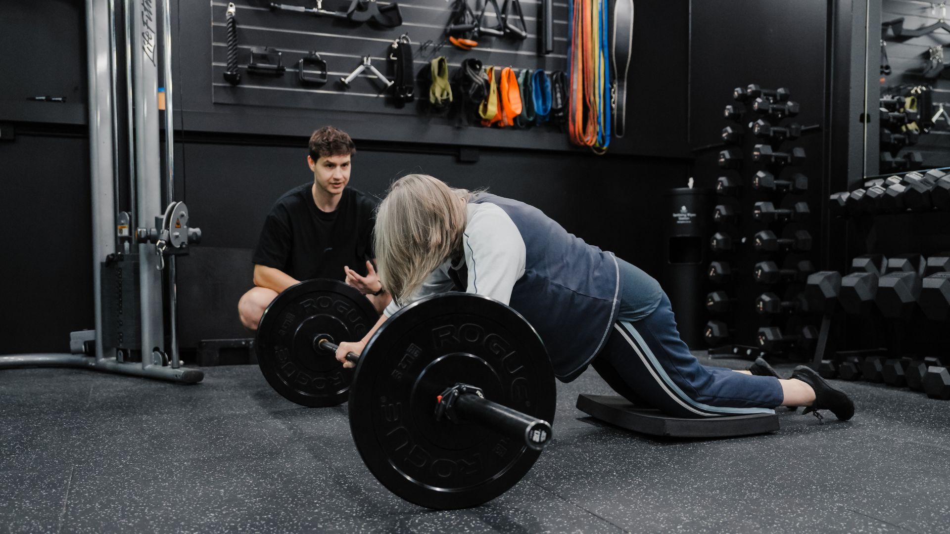 Personal trainer coaches a member through a barbell strength exercise at Habitat Gym Prestons, focusing on proper technique and safe movement. 