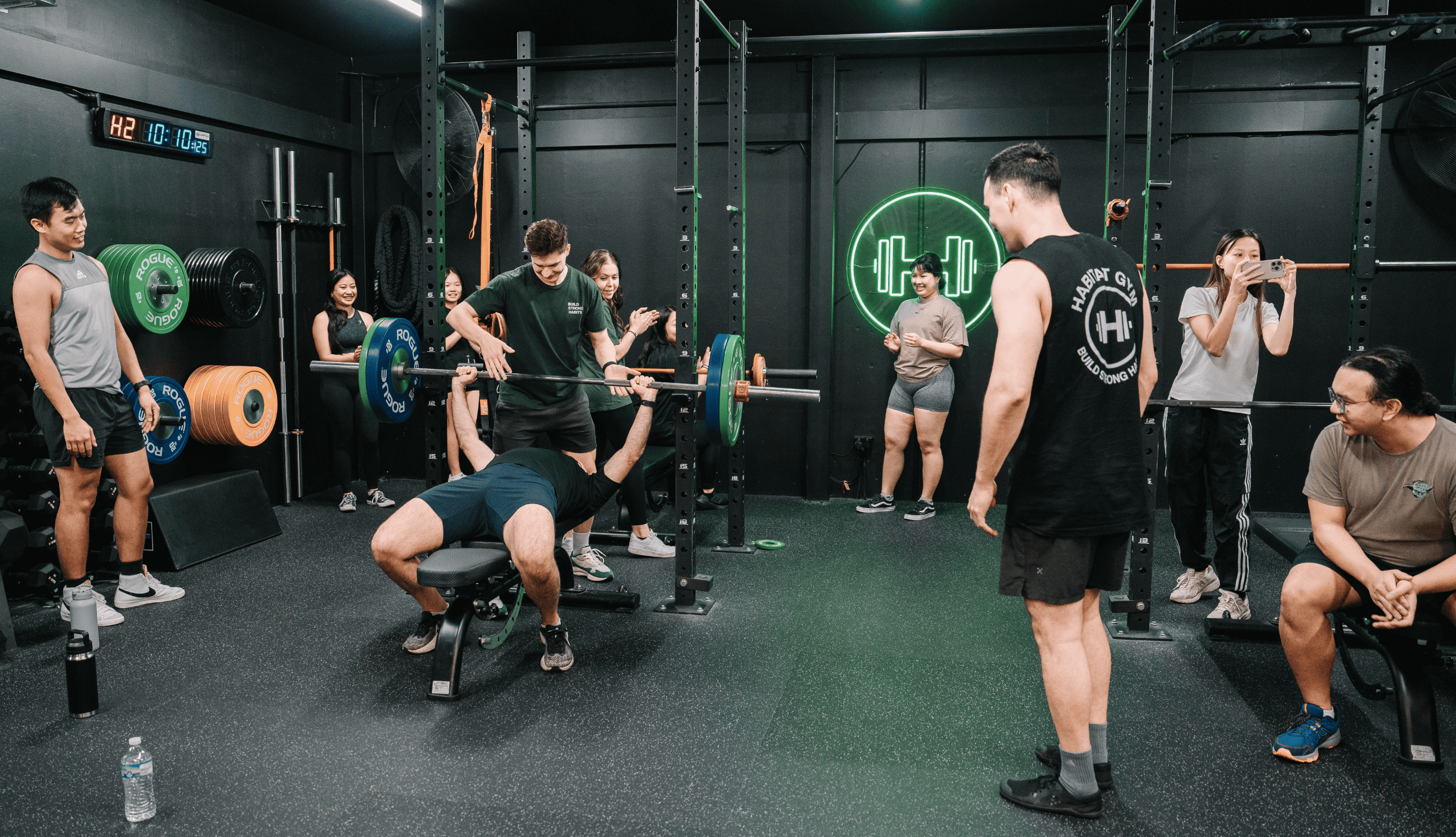 Coach assisting a gym member while doing bench press at the Habitat Gym in Prestons