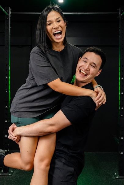Jeannie and Ben, coaches and co-founders of Habitat Gym, sharing a happy moment inside the gym