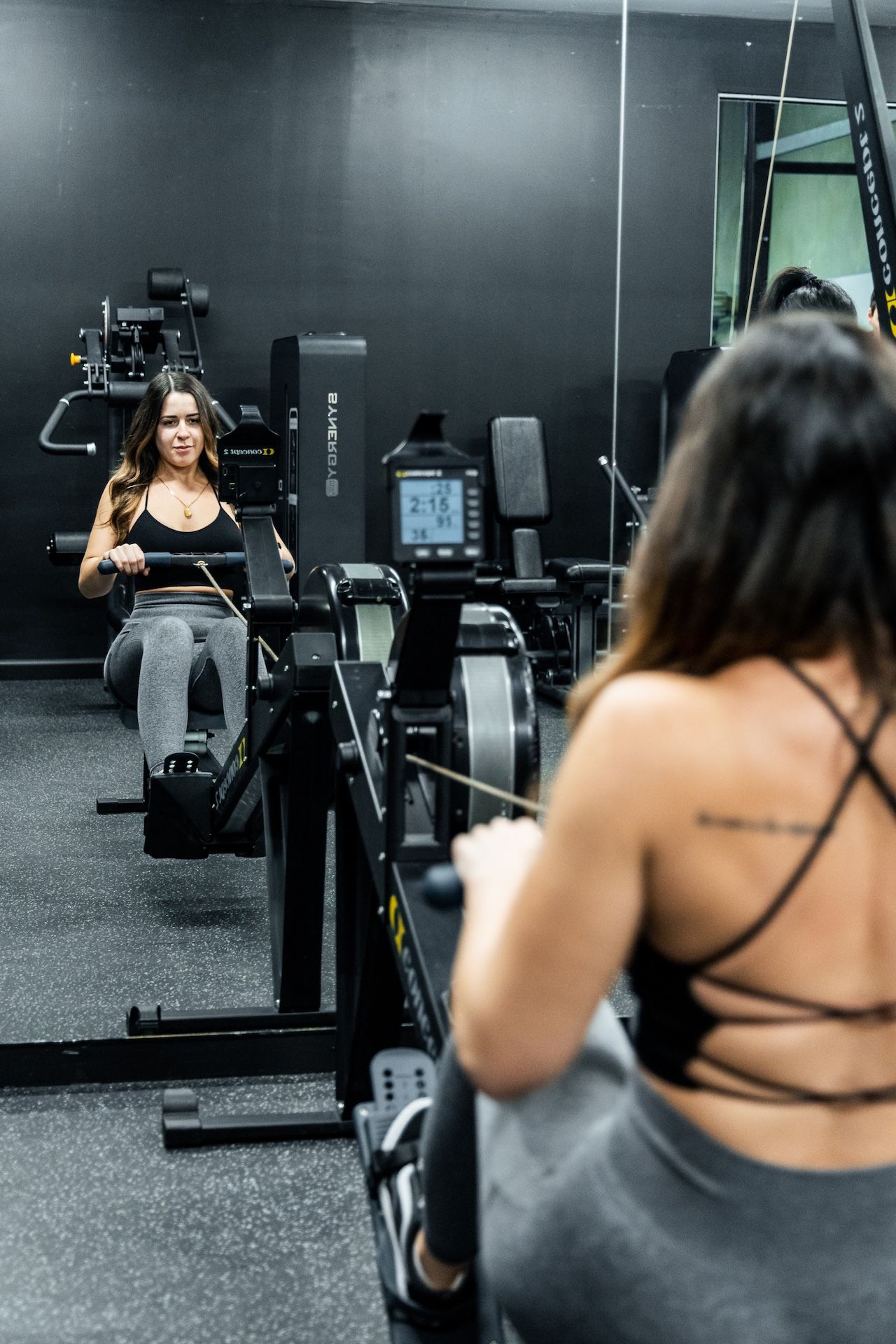 Female gym member using Concept2 rowing erg machine in Habitat Gym’s cardio area