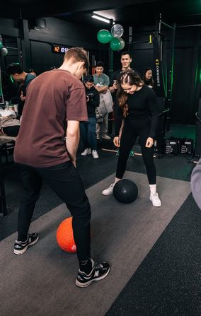 Friendly fun competition between gym members with medicine slam balls attending a workshop inside Habitat Gym Prestons