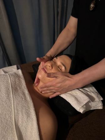 Member receiving a calming facial treatment as part of post-training recovery at Oasis Wellness Spa
