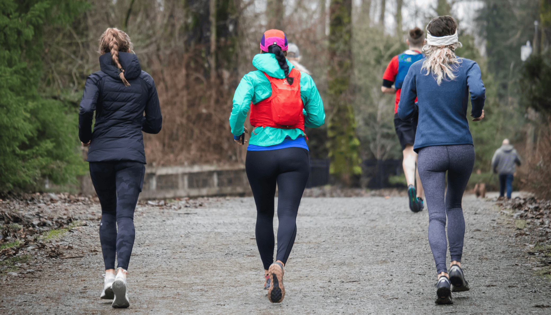 Group of people jogging outdoors during winter