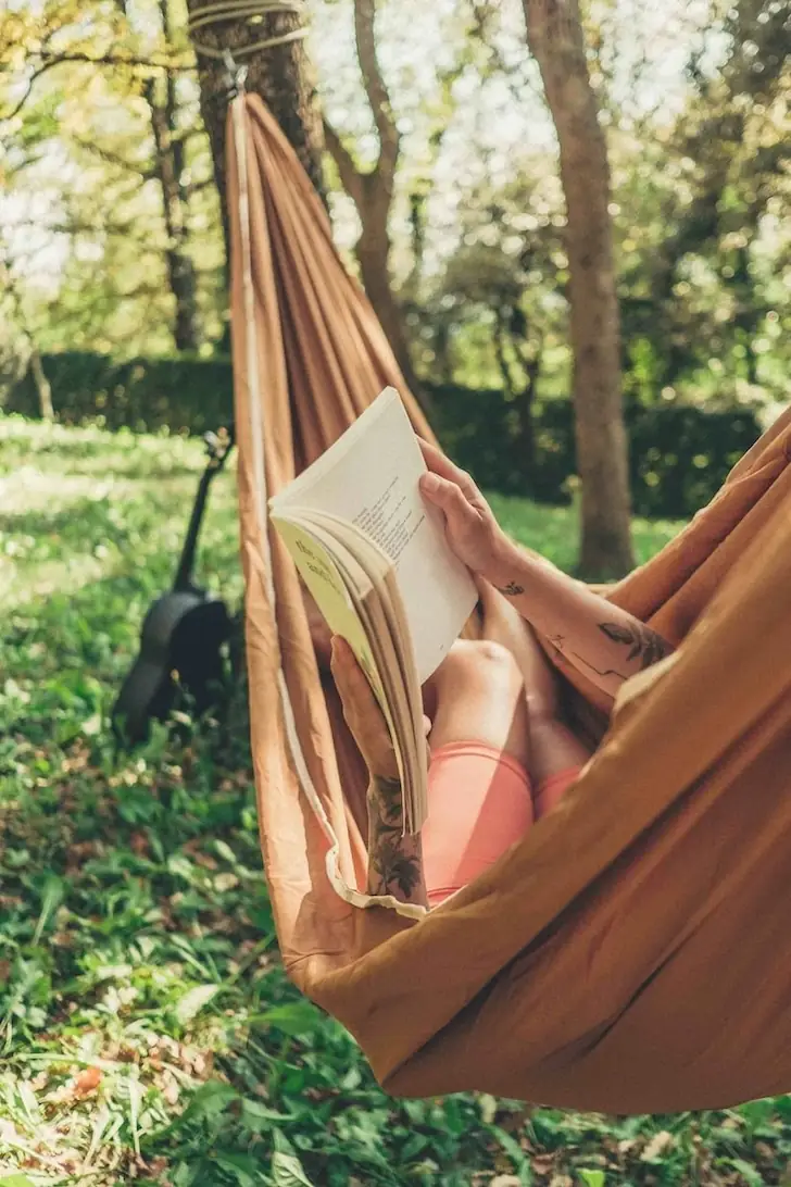 Person in a hammock reading a book