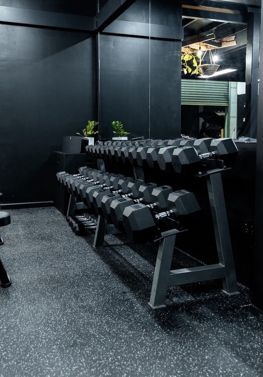 Sleek dumbbell rack setup inside Habitat Gym in Prestons, showcasing a clean, private training space with high-quality strength equipment