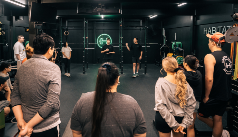 Habitat Gym coaches and gym members doing a huddle at the gym