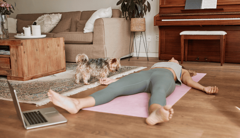 Woman resting on floor post-workout after intense strength training